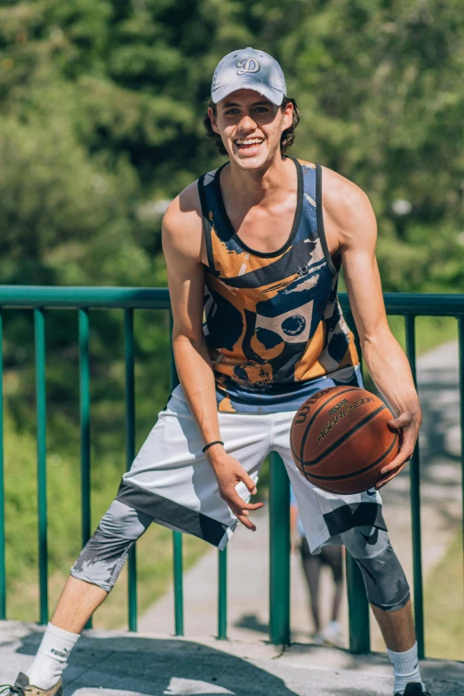 a man holding a basketball in his right arm