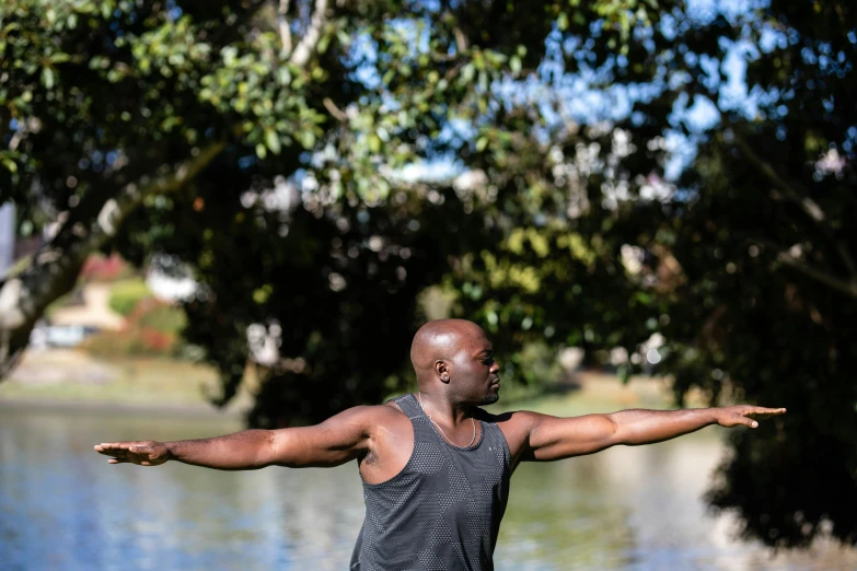 a person is doing yoga with arms stretched out