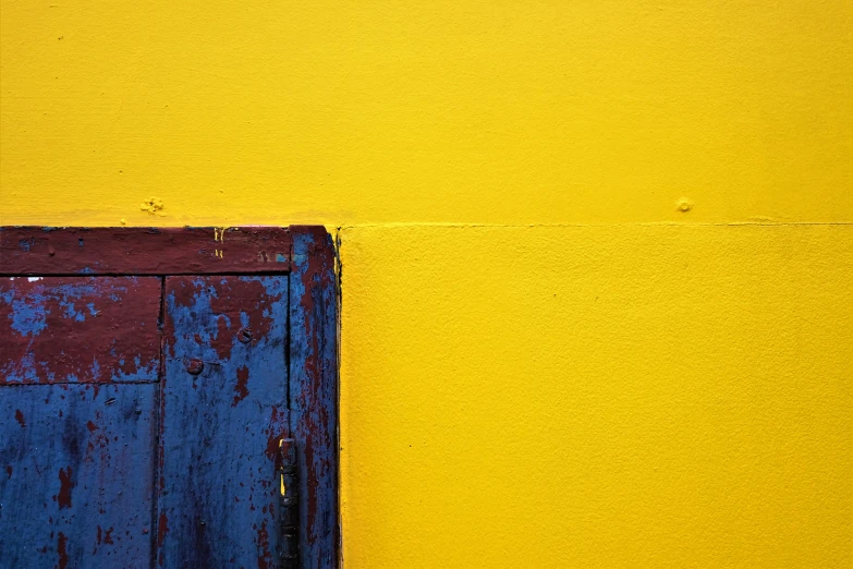 close up of the blue and yellow paint on the wall