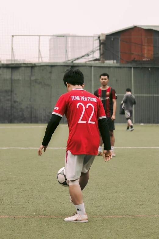 soccer players in red uniforms playing soccer with one another
