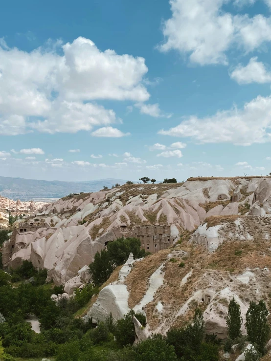 a very large hill with many small hills in the background