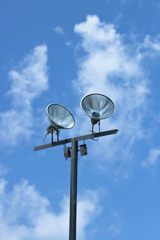 an outdoor street light on the side of the road