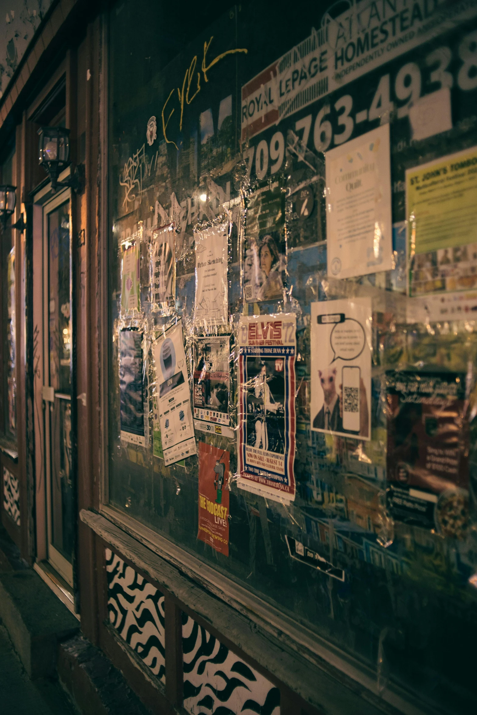 signs and other items are taped to the side of the building