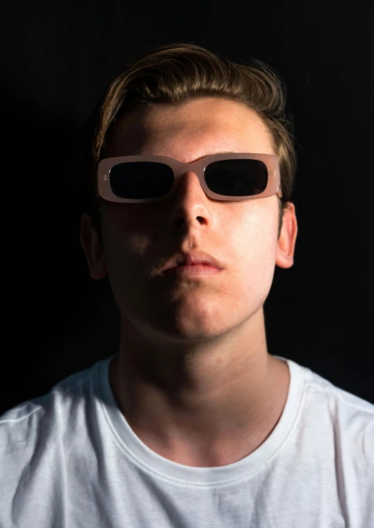 a young man wearing two glasses with the same person's face