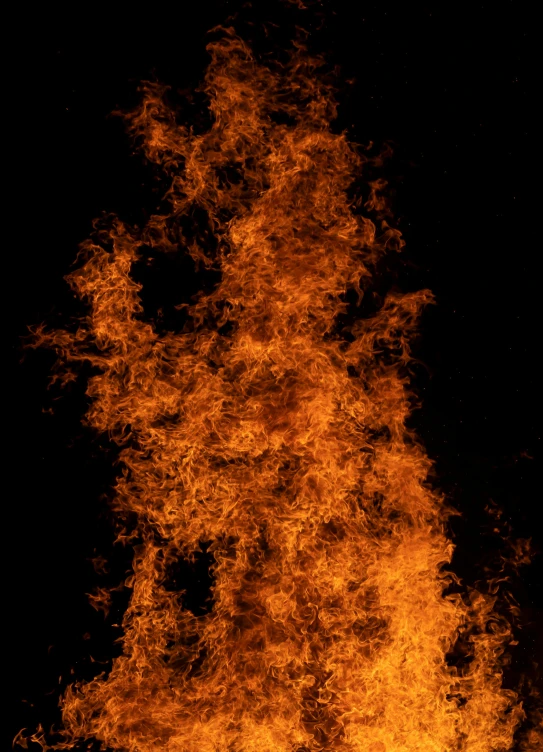 an orange fire with several small amounts of fire in it