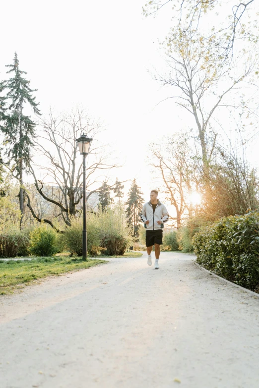 the man is jogging down the road during the daytime