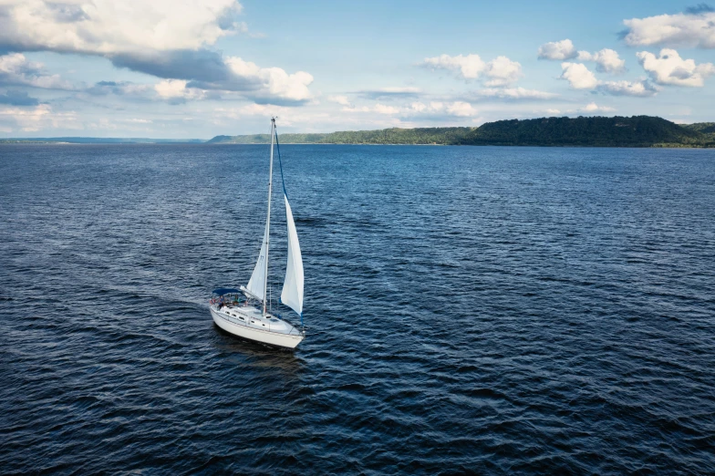 a sail boat in a body of water