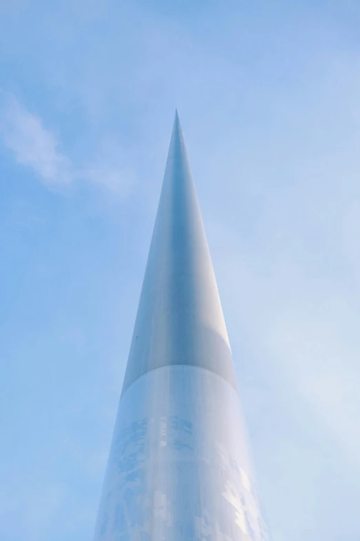 a tall cone shaped structure with snow on it's side