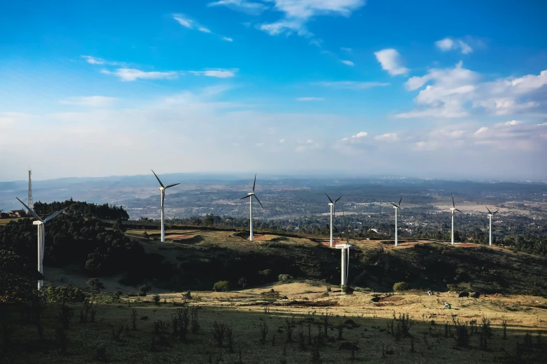 there are many windmills on top of this hill