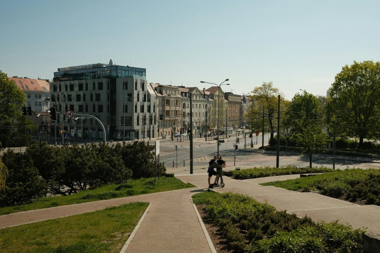 a woman walking down a path that is between two buildings