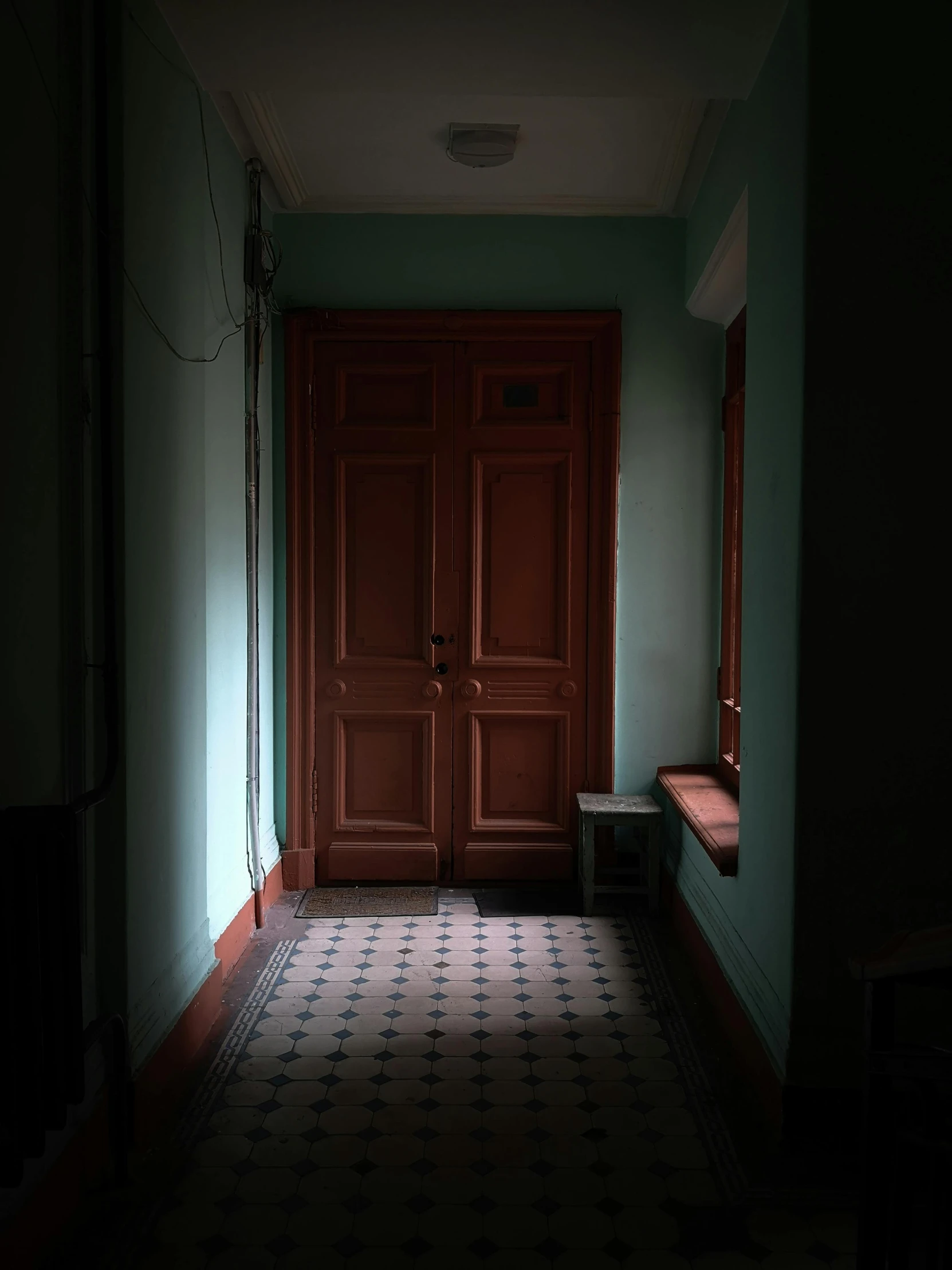 a dimly lit room with some doors and windows