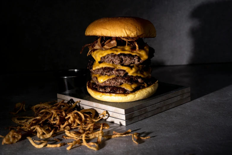 a large burger is next to some chips