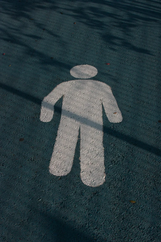 a white outline of a person is on a parking lot