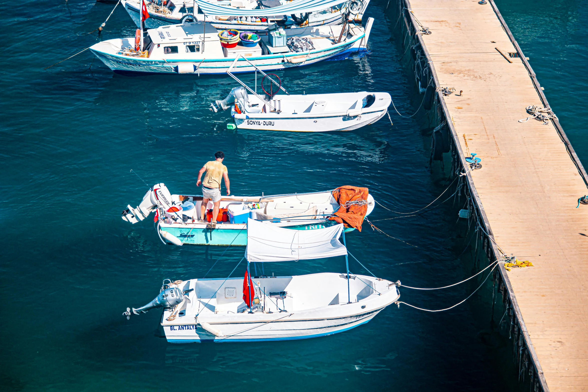 a few boats docked along a pier in the water