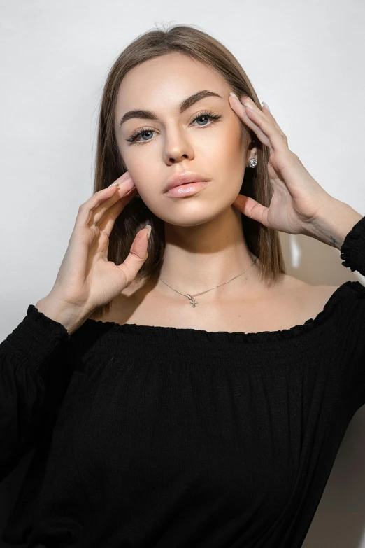 a young woman with a small diamond necklace