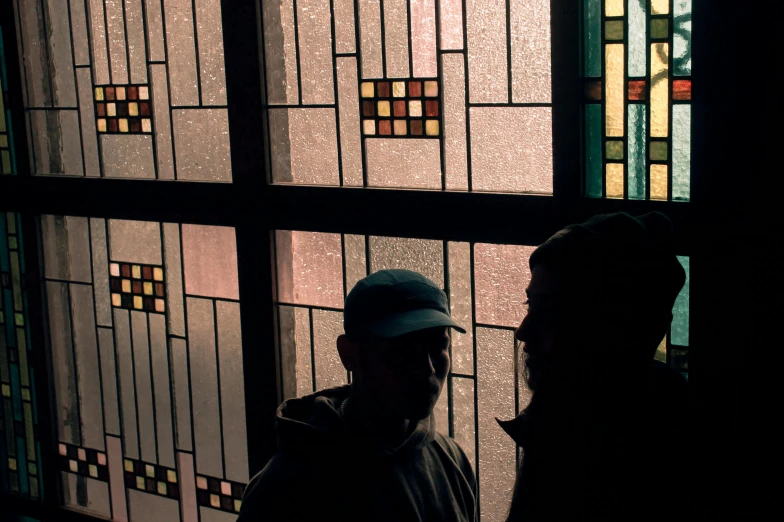 a man standing in front of stained glass windows