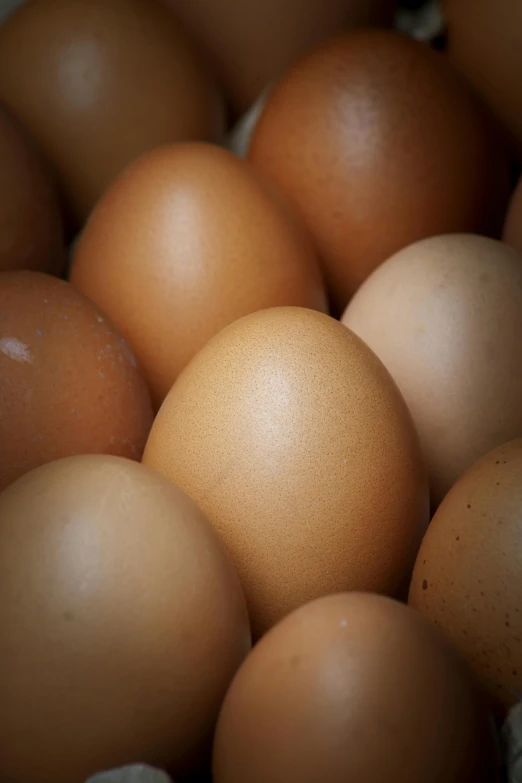 the brown eggs are stacked close together