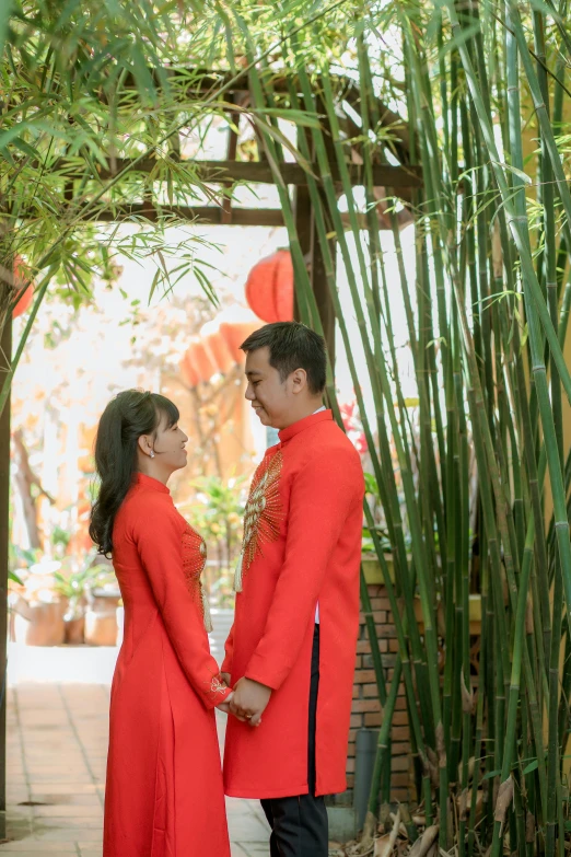 an asian couple looking at each other and smiling together