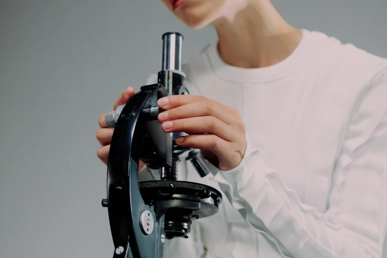 a woman using a microscope on a table