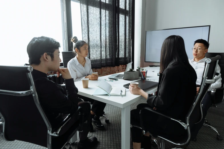 three business people having a meeting in an office