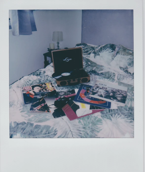 there is a suitcase and some other items on the bed