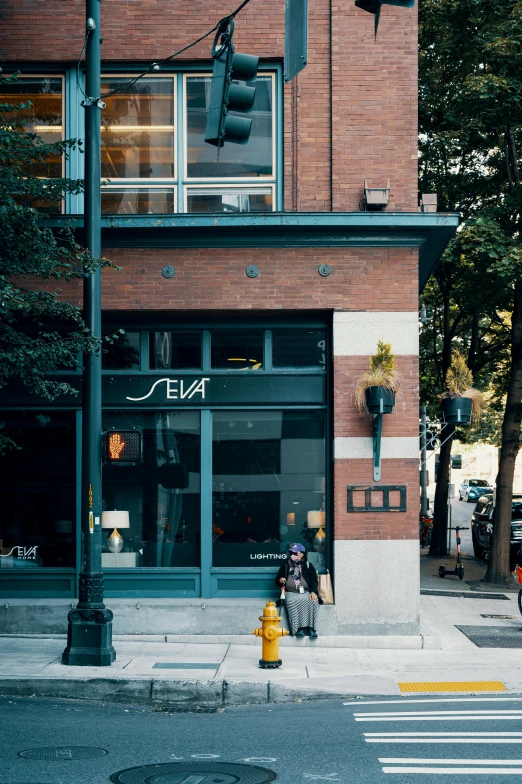 a person on a sidewalk under a traffic light