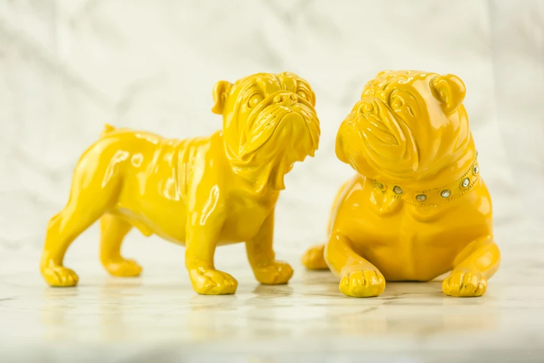 a close up of two figurines with a bulldog in between them