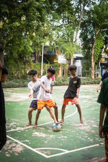 a group of s on a green court playing soccer