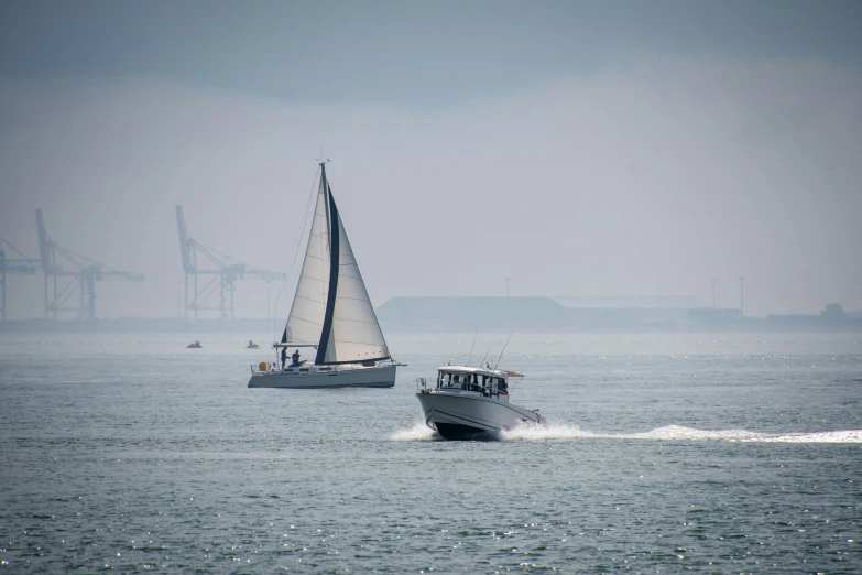 two boats float in the ocean as they pass each other