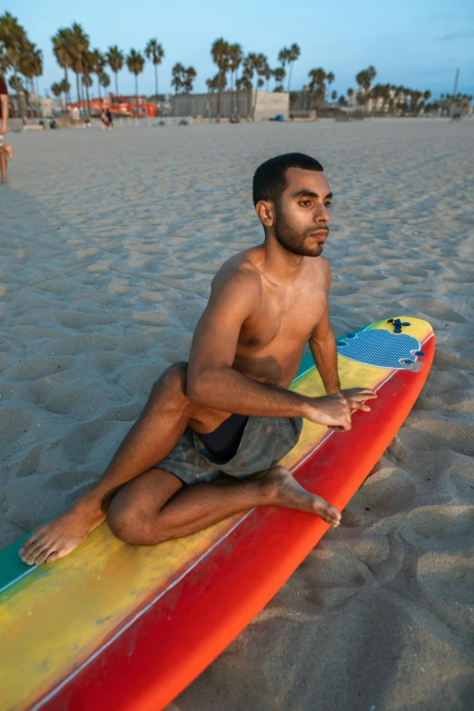 a man with  sits on top of a surfboard