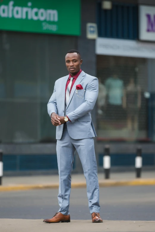 a person in a suit standing on the street