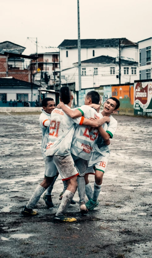 the players in the rain are hugging each other