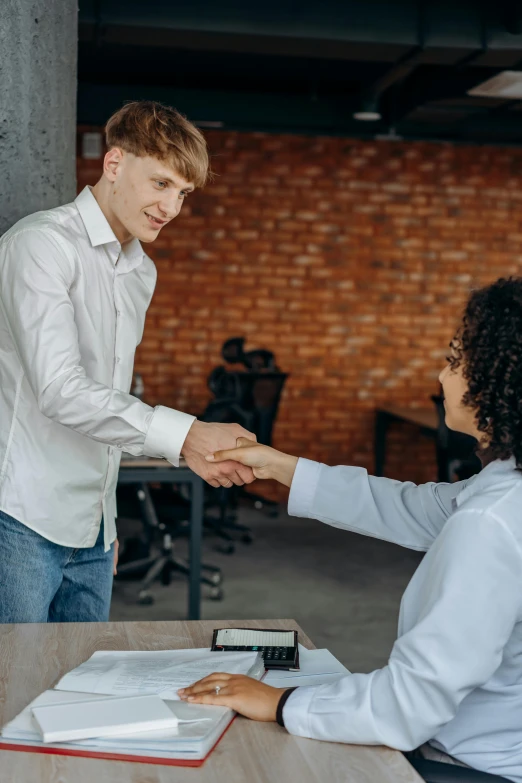 a person that is shaking another persons hand