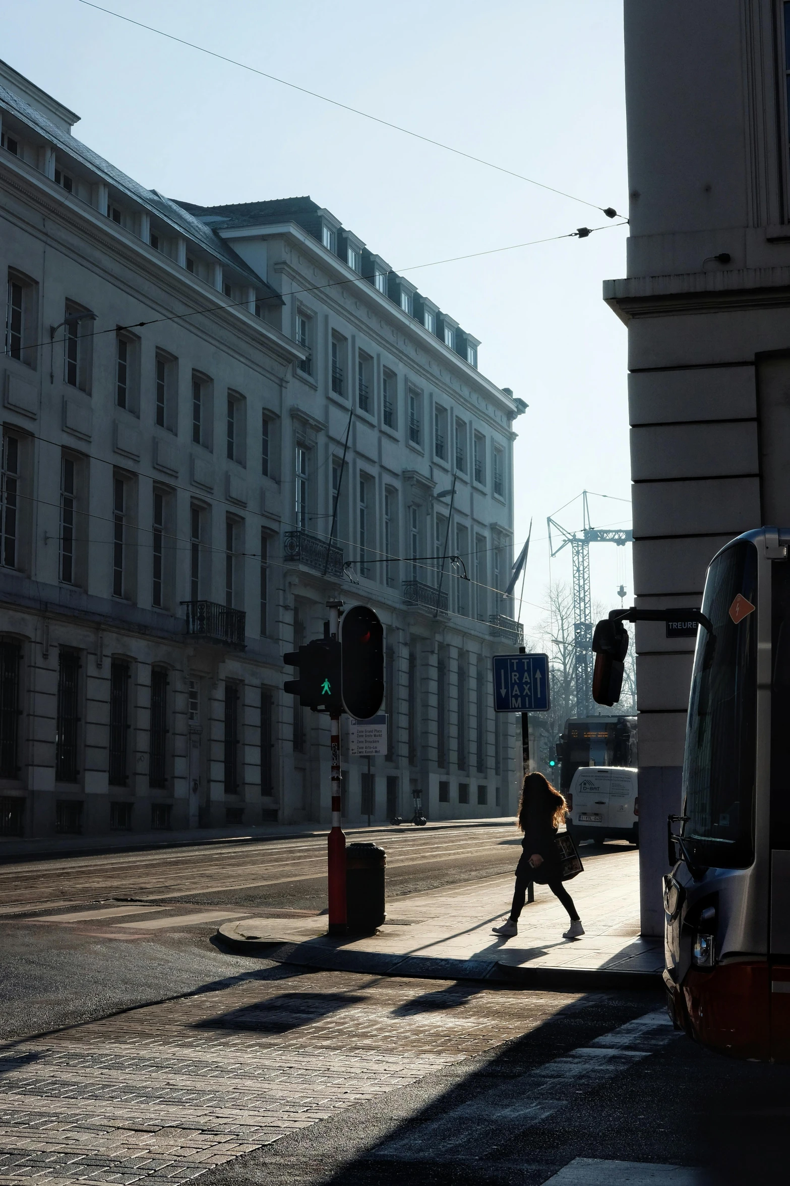 a man walks across a deserted street