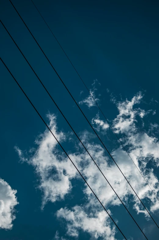 a high power line with sky and clouds