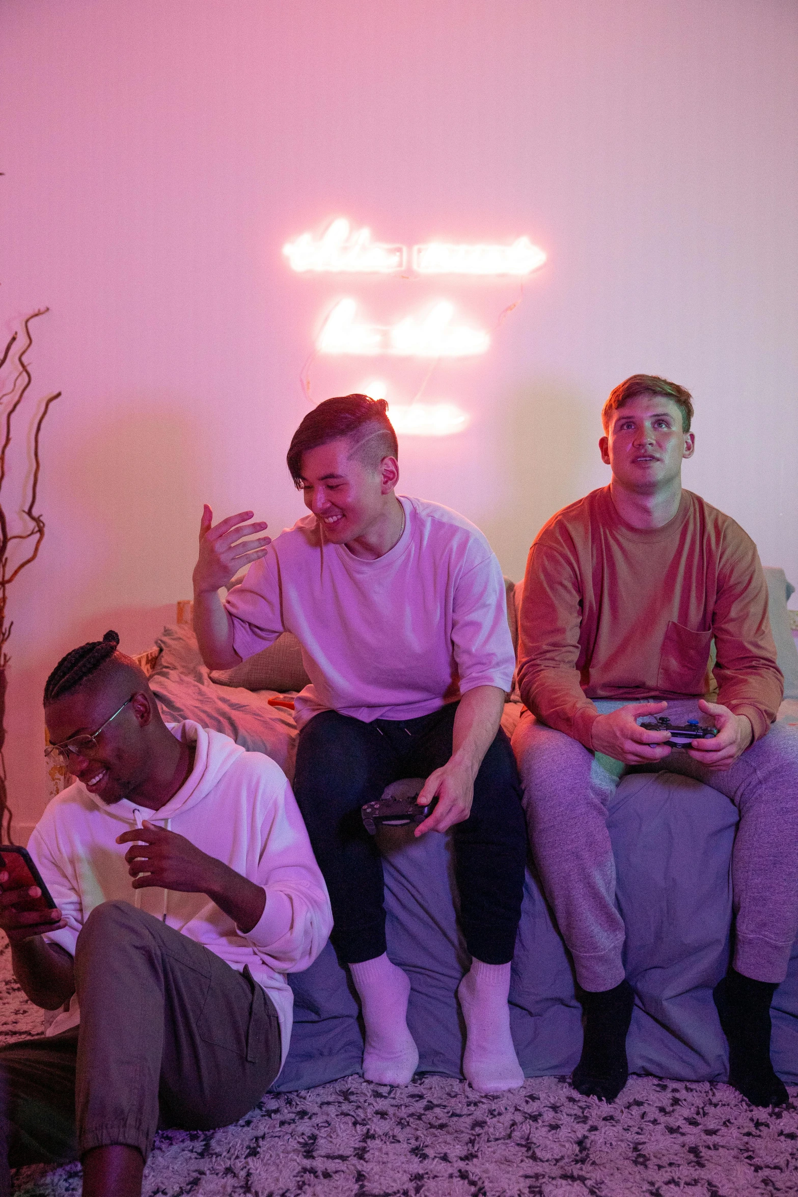 four men sitting next to each other while drinking