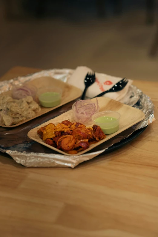 some food is laying out on top of aluminum wrappers