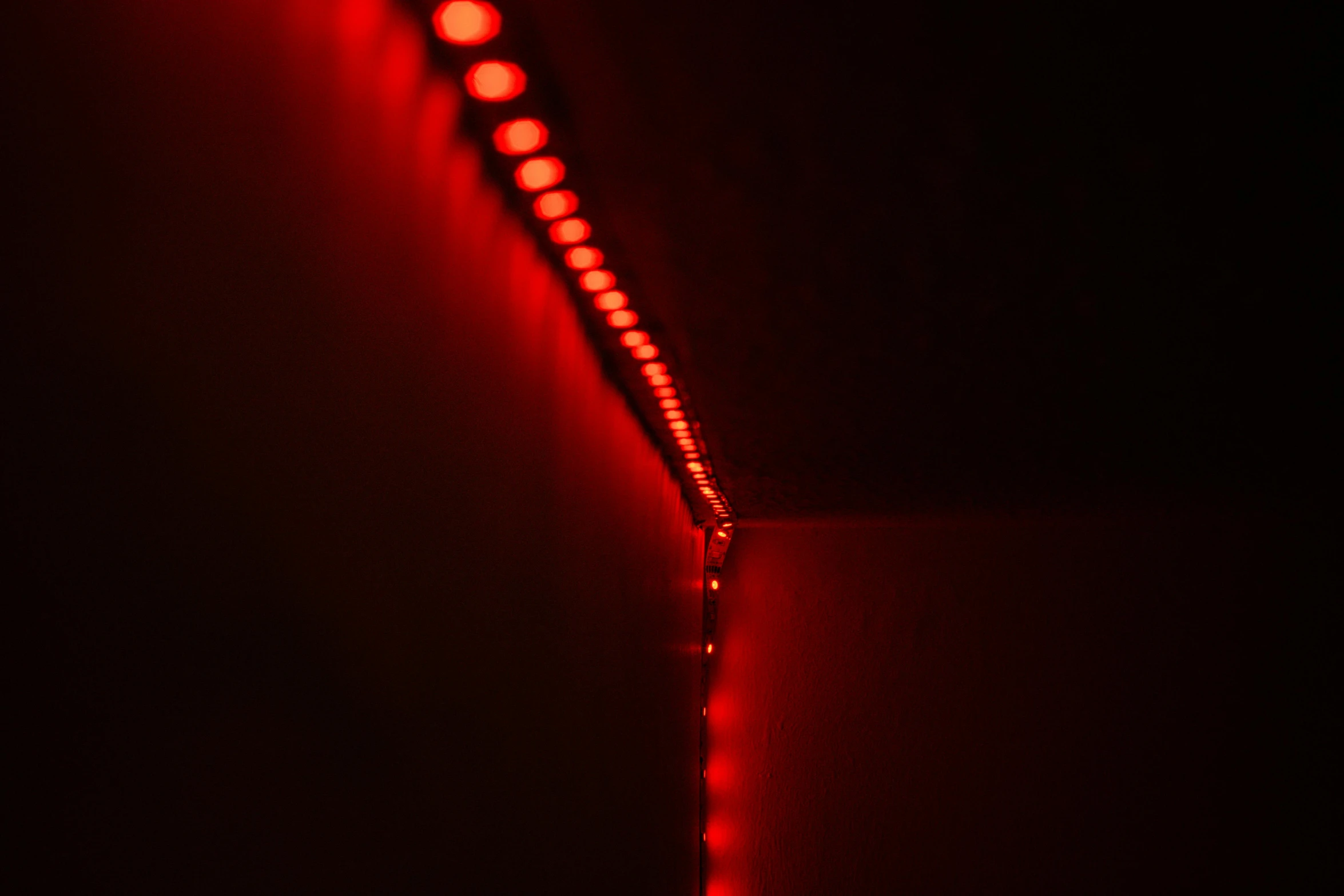 a red light sitting on top of a wall