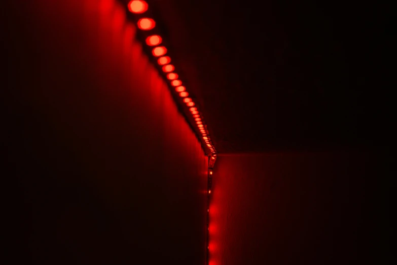 a red light sitting on top of a wall
