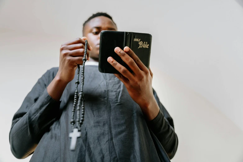 a woman in a priests shirt is holding a book