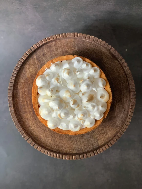 a dessert in a wooden bowl on a table