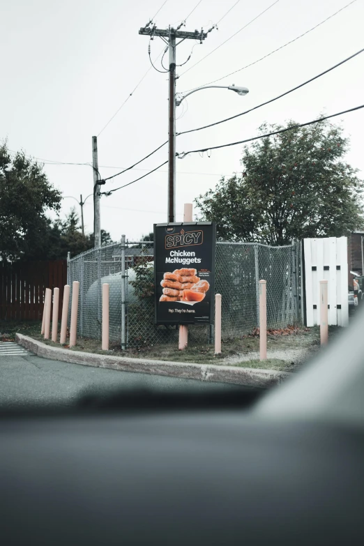 the sign is up behind a chain link fence