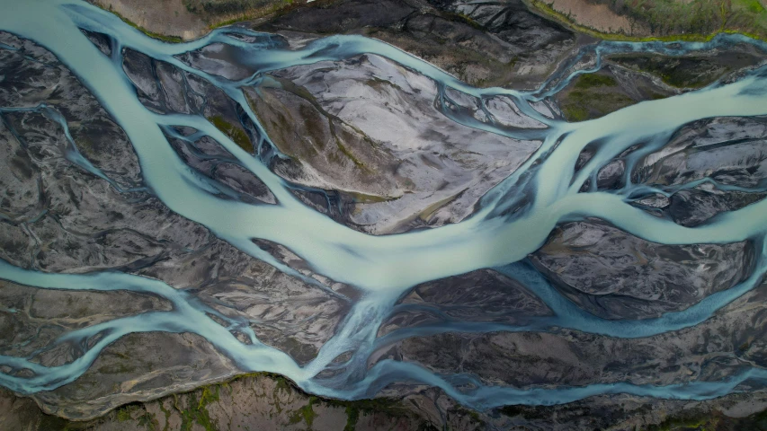 an aerial view of a river running through a mountainside