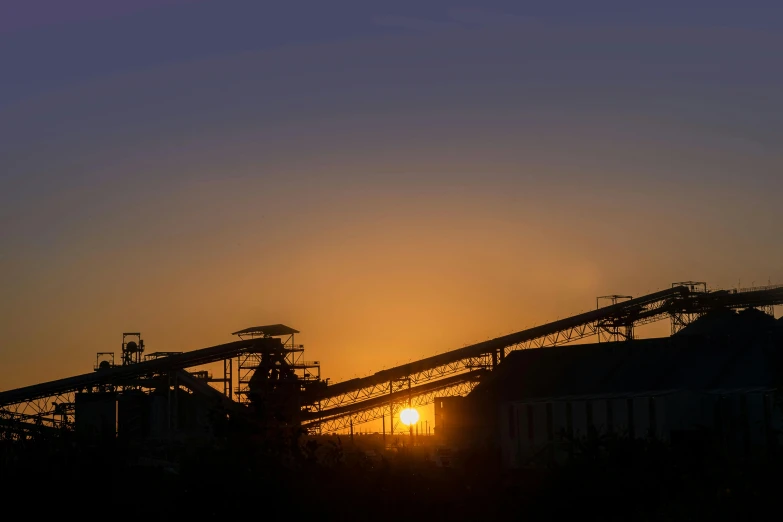 a large group of industrial equipment at sunset