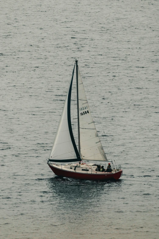 there is a sailboat in the water with its sails down