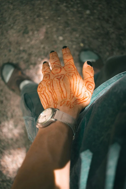 an overhead view of someone's hand with orange hands
