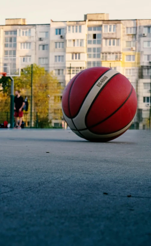 a red and white ball is sitting in the street