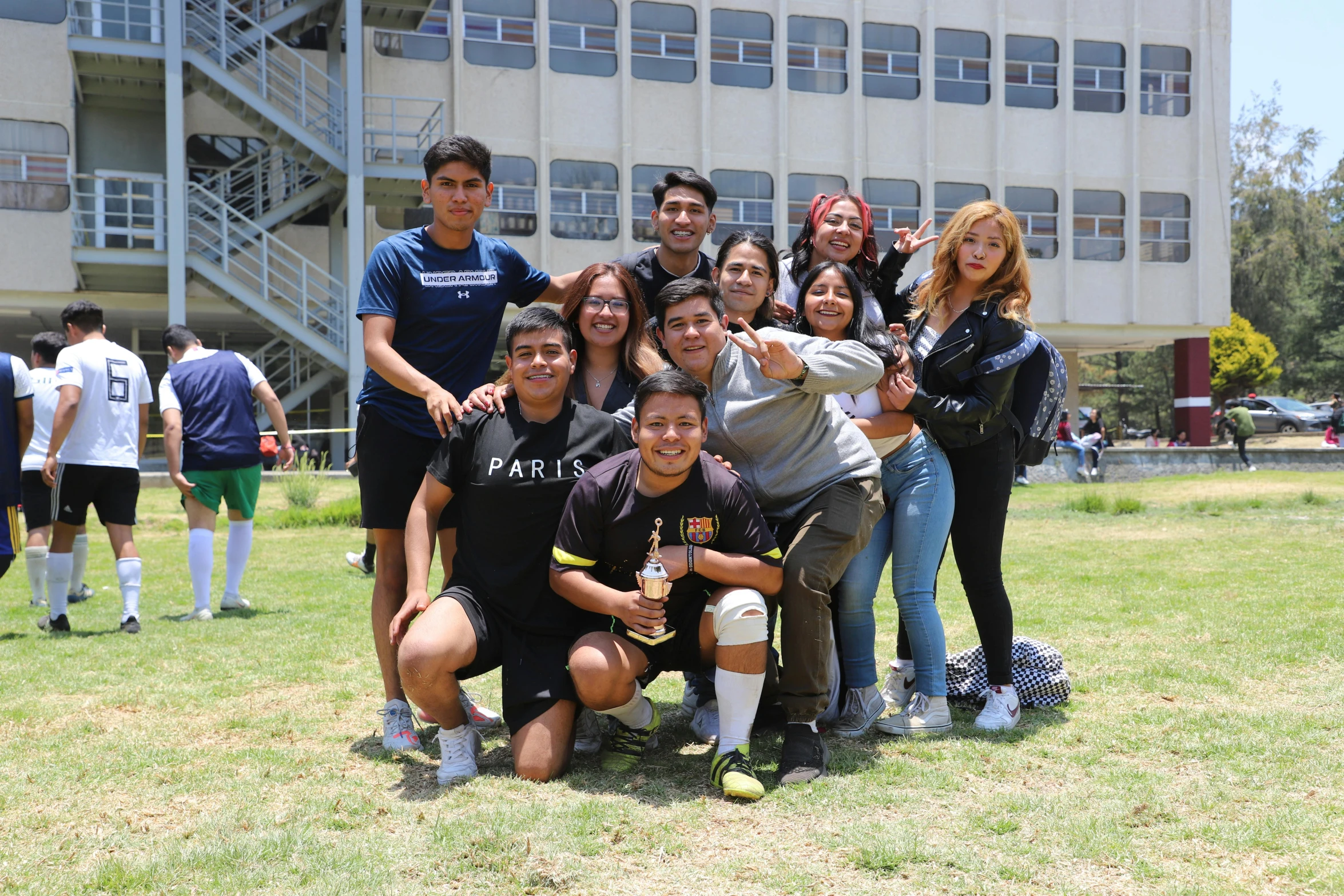 some people standing on the grass and posing for a po