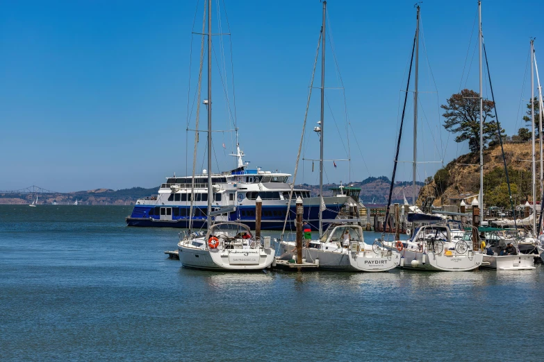 a bunch of boats in the water with rocks near by