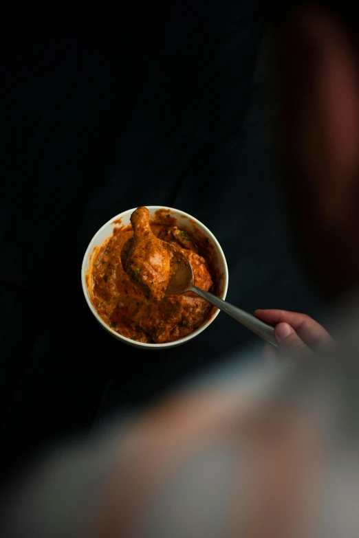 the bowl of food is being held up by someone